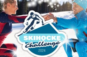 Skihocke-Challenge Werbebild mit 2 Personen in Knieposition im Schnee